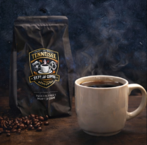 Tennessee Coffee bag and steaming cup on a dark background