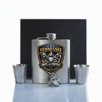 Stainless steel flask with 'Tennessee Dept of Coffee' logo and accessories on a white background