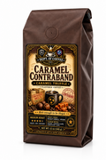 A 12 oz bag of Dept. of Coffee Caramel Contraband Caramel Truffle flavored coffee, shown on a solid black background.