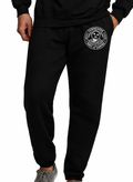 Black sweatpants with a circular white graphic on the upper left thigh, shown on a model from the waist down against a white background.