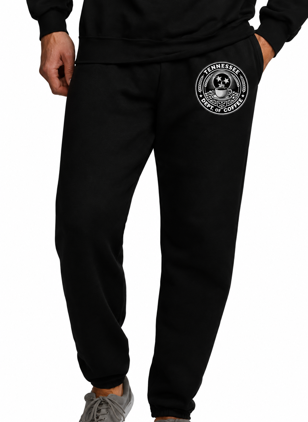 Black sweatpants with a circular white graphic on the upper left thigh, shown on a model from the waist down against a white background.