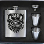 Stainless steel flask with 'Tennessee Dept. of Coffee' design and two cups on a black background